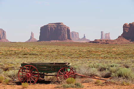 red and brown wagon near brown mountain thumbnail