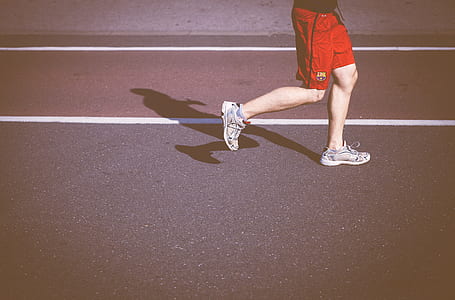 person wears white running shoes while jogging thumbnail