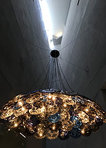 black and yellow chandelier between two walls thumbnail