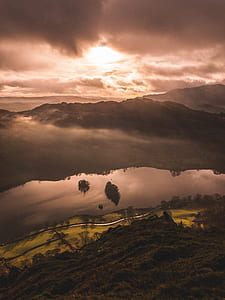 portrait photography of mountain and body of water during daytime thumbnail