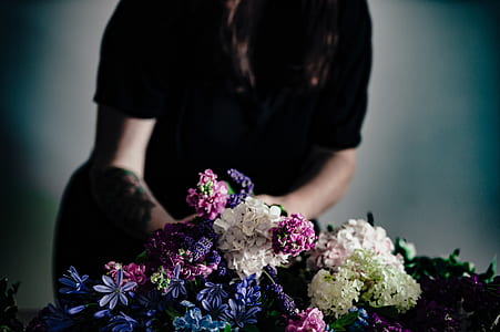 women's wearing black t-shirt holding bouquet thumbnail