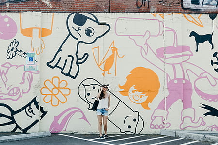 woman standing on graffiti wall thumbnail