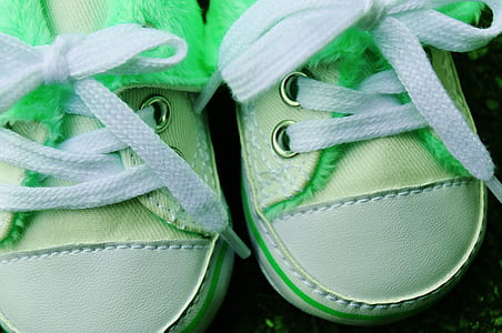closeup photo of pair of baby's yellow-and-white crib shoes thumbnail