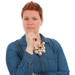 woman holding her chin wearing blue denim jacket thumbnail