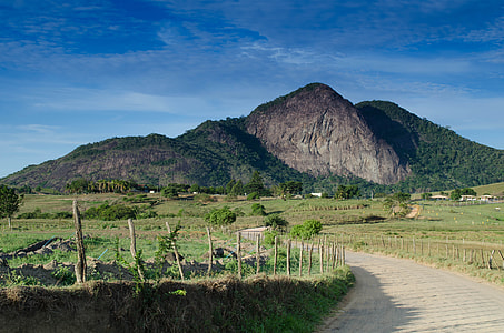 mountain and green field during daytime thumbnail