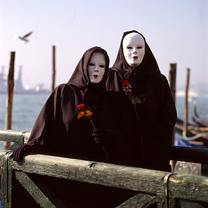 two person wearing black capes and white masks thumbnail