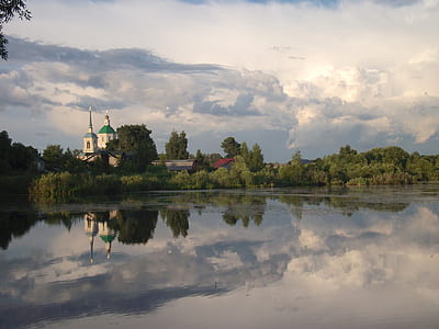 wide angle photo of body of water under cloudy sky thumbnail