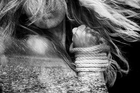 grayscale photo of woman tied both hands with road thumbnail