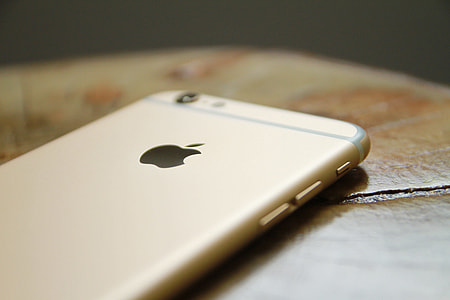 close-up photo of gold iPhone 6 on brown wooden top thumbnail
