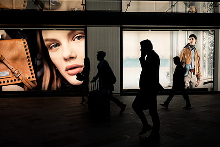 silhouette of people walking near posters thumbnail