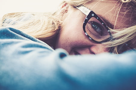 woman wearing blue long-sleeved shirt and black-frame eyeglasses portrait photography thumbnail