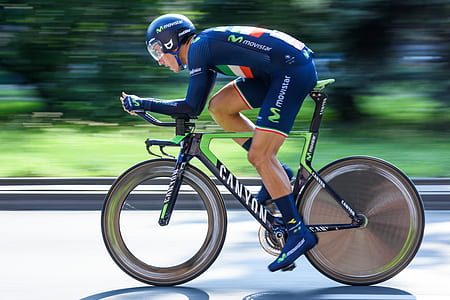 man riding green, black, and white Canyon road racer bike thumbnail