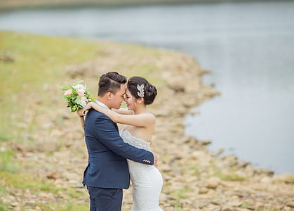 Newly Wed Coupe Standing Near Body of Water thumbnail