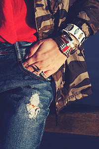 person wearing distressed blue denim bottoms thumbnail