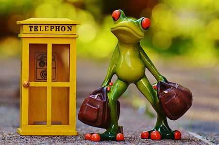 green ceramic frag standing beside telephone booth figurine thumbnail