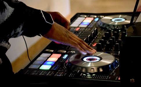 person using black and gray DJ controller thumbnail