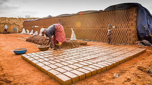 person touching the ground and basin near bricks under white sky during daytime thumbnail