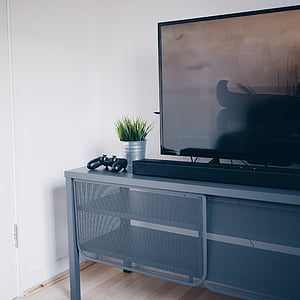 flat screen TV on grey steel TV bank thumbnail