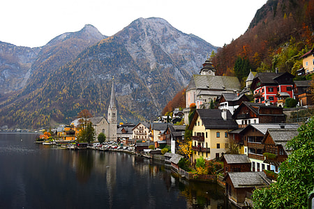 brown houses beside mountains and body of water thumbnail
