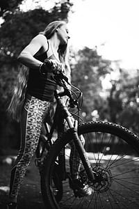 grayscale photo of woman using hardtail bicycle thumbnail