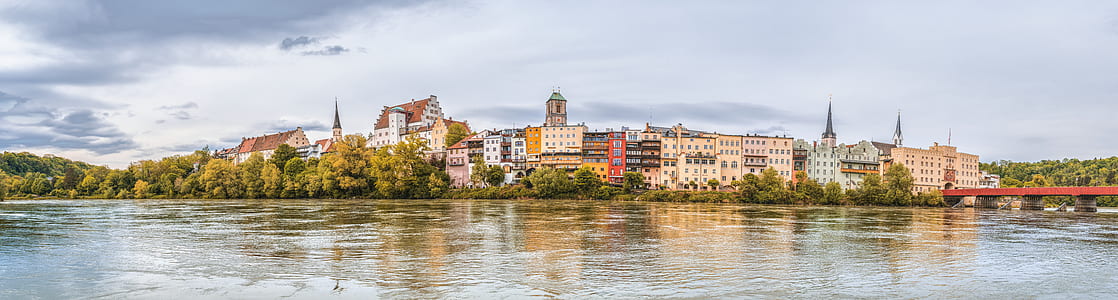 houses surrounded by trees beside body of water during daytime thumbnail