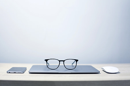 Glasses sitting on laptop thumbnail