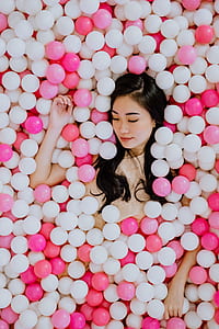 woman lying on pitballs thumbnail