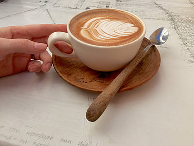person touching mug with brown liquid thumbnail