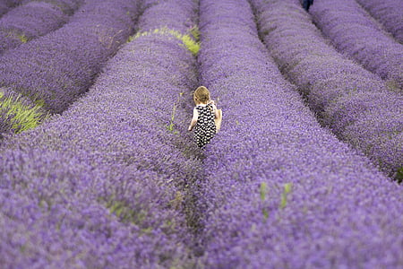 girl standing on flower garden thumbnail