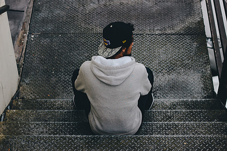 man sitting on silver staircase thumbnail