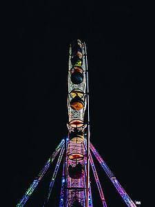 people riding on lighted Ferris wheel at night thumbnail