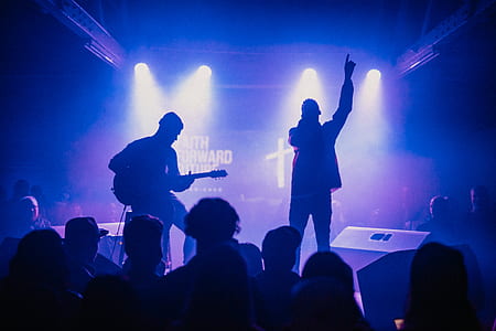 silhouette two man performing on stage thumbnail