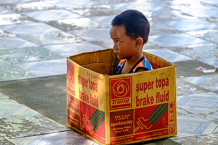 boy sitting inside box thumbnail