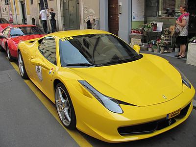 yellow Ferrari 458 Italia coupe parked beside concrete building at daytime thumbnail