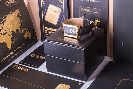 gold-colored analog watch on box thumbnail