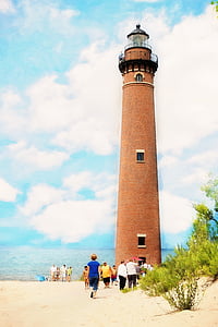 people walking at base of beige lighthouse thumbnail