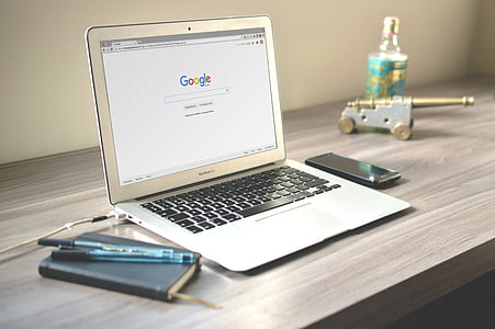 MacBook Air on wooden table thumbnail