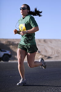 woman running on road during daytime thumbnail