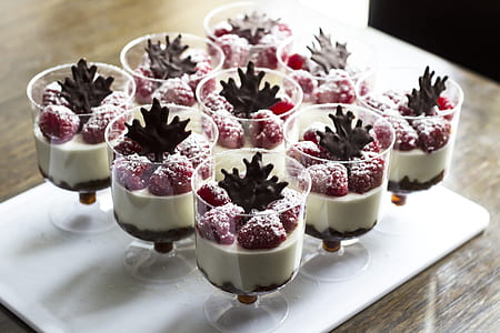 nine clear footed glasses on top of white tray filled with creams and strawberries thumbnail