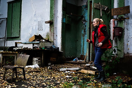 woman in red vest standing near wall thumbnail
