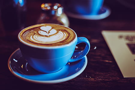 cappuccino in blue ceramic cup on round blue ceramic saucer thumbnail