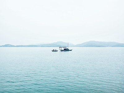 black sailboat on body of water during daytime thumbnail