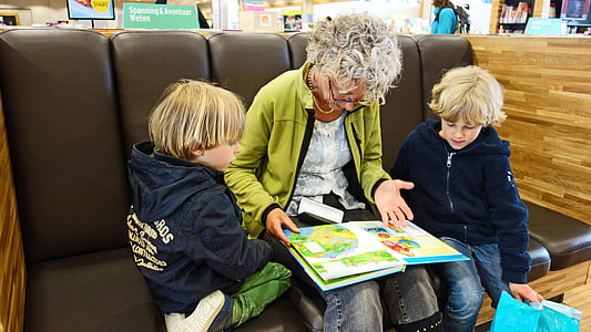 woman with two kids reading book thumbnail