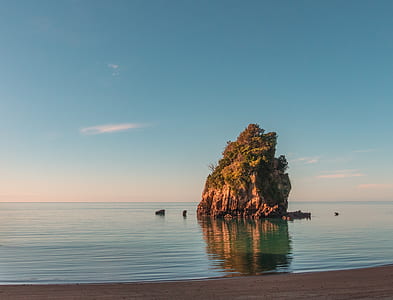 rock formation surrounded of body of water thumbnail
