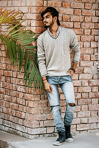 man leaning on red concrete wall thumbnail