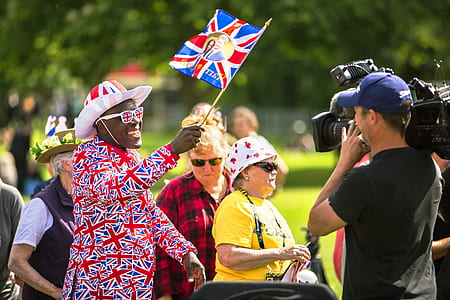 man taking video of man wearing flag of U.K. thumbnail