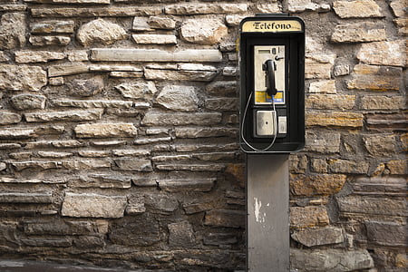 gray and black telephone on brown brick wall thumbnail