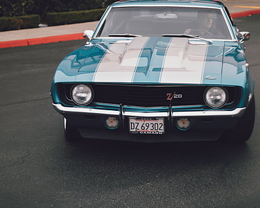 green Chevrolet Z28 on gray road during daytime thumbnail