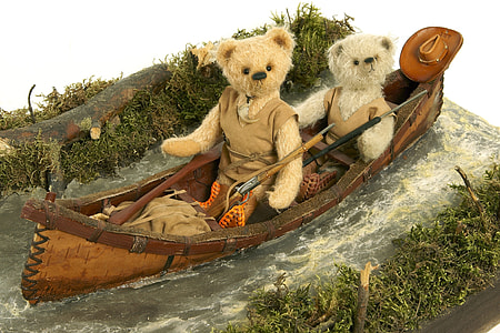 two teddy bears riding on canoe photo thumbnail