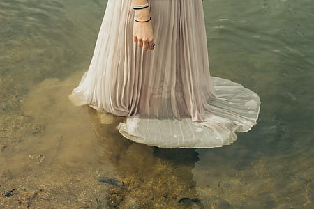 woman in grey dress on top of water thumbnail